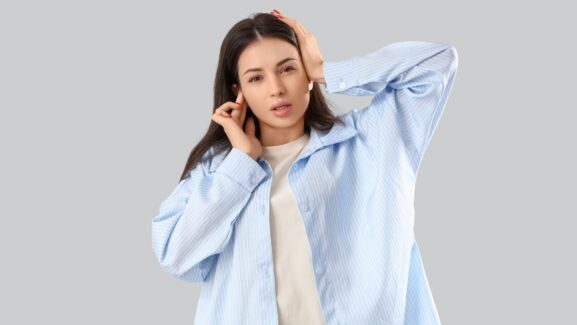 Woman suffering from tinnitus